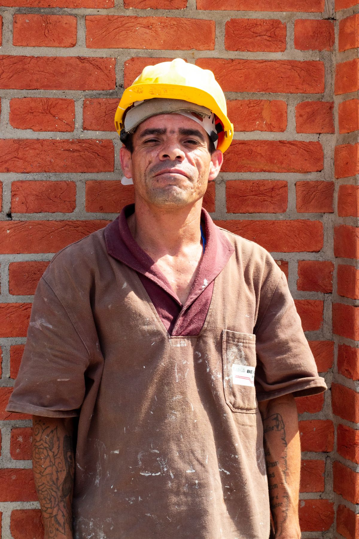 A UK builder on site in a hard hat